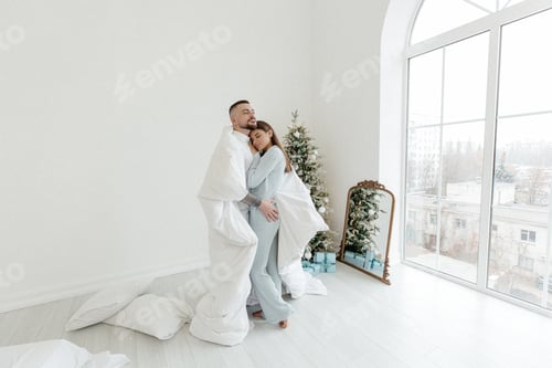 Preview: Loving Couple Embrace near Holiday Tree Indoors
