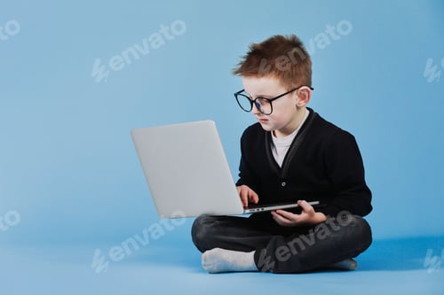 Preview: Distance learning online education. Schoolboy studying at home with laptop and doing school homework