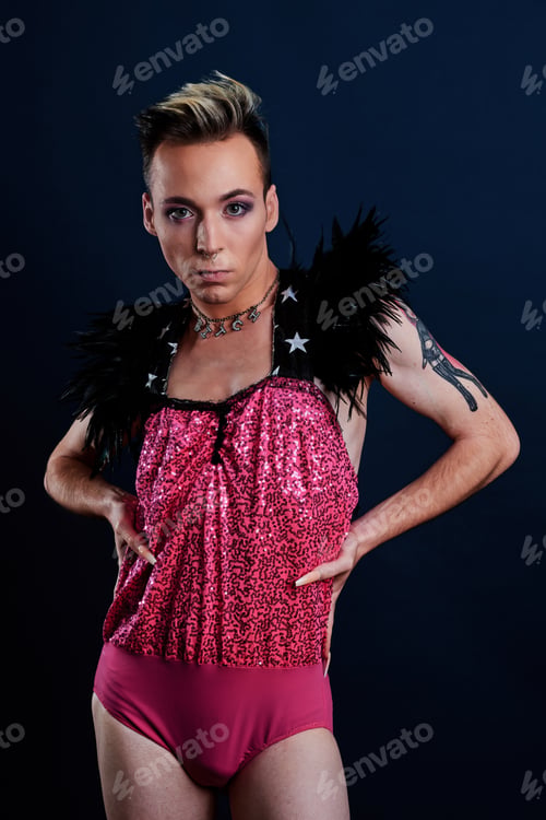 Preview: young transgender model with pink dress and dark blue background