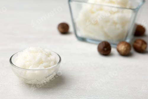 Preview: Shea butter in bowl and nuts on table