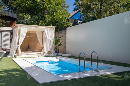 Preview: House leisure area, backyard with pool, tropical plants in the backyard of a luxury home. Industrial