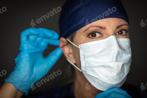 Preview: Female Doctor or Nurse Wearing Surgical Gloves Putting On Medical Face Mask