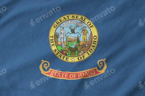 Preview: Idaho US state flag depicted on folded wavy fabric of old cloth