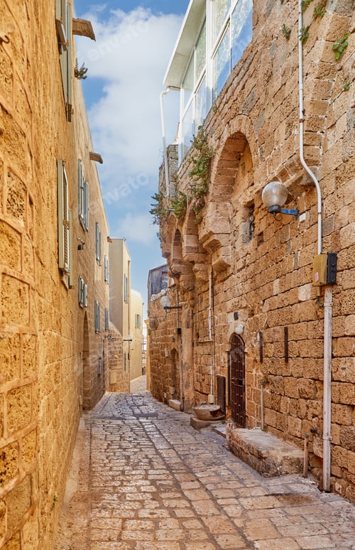 Preview: Stone narrow streets of the Old City of Jaffa against blue sky with clouds