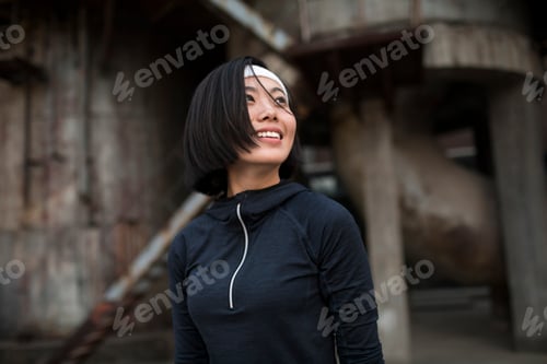 Preview: Young woman resting after running