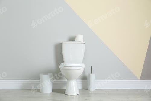 Preview: Simple bathroom interior with new toilet bowl near color wall
