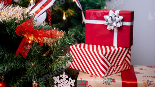 Preview: Neatly wrapped gift boxes beneath the contemporary Christmas tree in home, Xmas