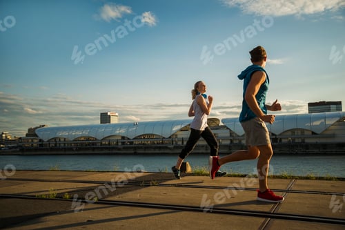 Preview: Young couple running by the riverside