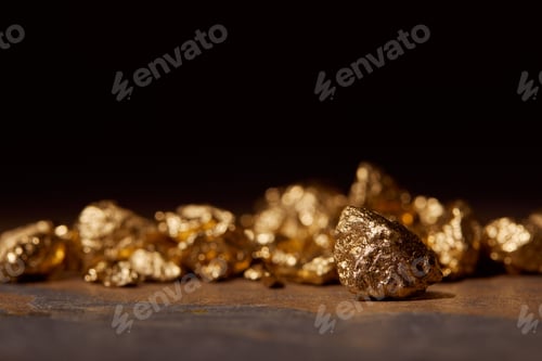 Preview: selective focus of golden stones on dark marble isolated on black