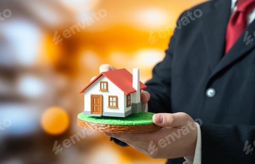 Preview: A man lays a house on a plot of land. Housing design and construction