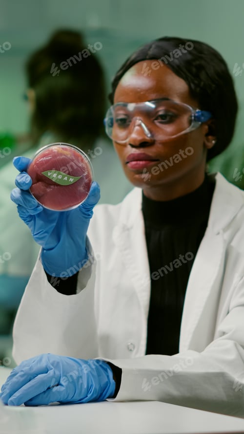 Preview: African chemist looking at lab-grown vegan meat sample