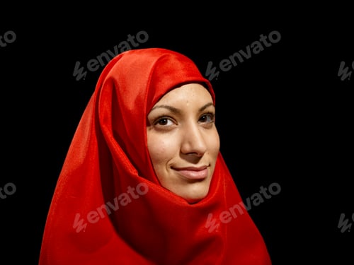 Preview: Woman wearing a red hijab made of a Turkish flag with a warm smile against a black background