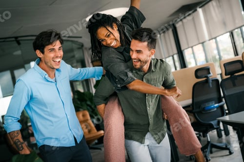 Preview: Happy diverse multiethnic colleagues having fun together, enjoying the celebration success in office