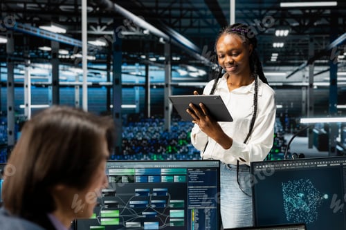 Preview: Smiling data center software developer using tablet, coding, managing systems