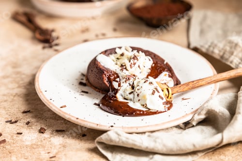 Preview: Chocolate fondant or lava cake with whipped cream, almond and chocolate pieces
