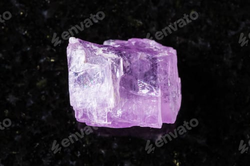 Preview: sample of raw kunzite crystal on black granite