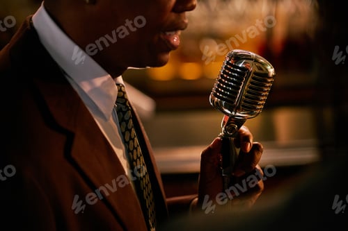 Preview: Black Male Vocalist Singing in Retro Stand Mounted Microphone in Bar