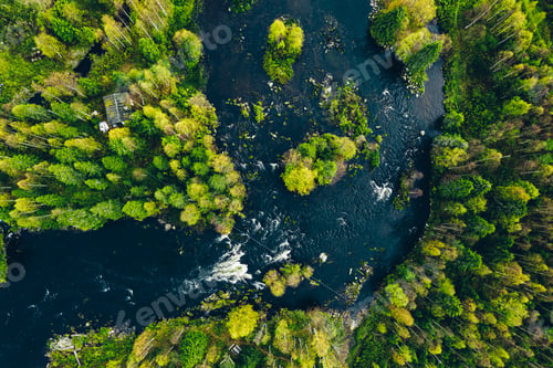 Preview: Aerial view of fast river in beautiful green spring forest in Finland.