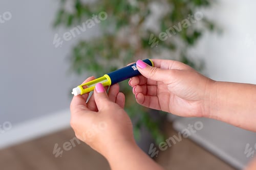 Preview: Woman holding an injection pen for diabetic. Insulin injection pen or insulin