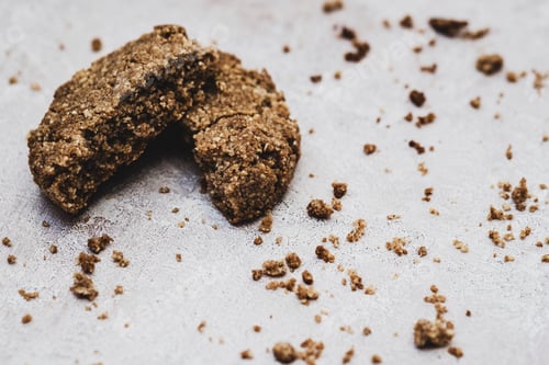 Preview: High angle close up of a freshly baked chocolate cookie broken in half.