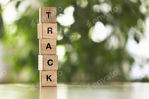 Preview: Five wooden cubes, blocks standing on table and showing word TRACK. Conceptual image about human