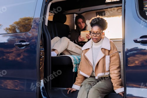 Preview: young african woman at sunset in camper van