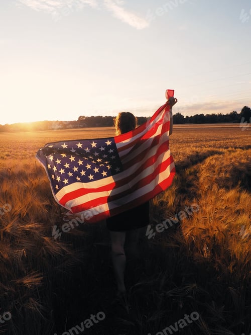Preview: Woman Holding an American Flag in Golden Field