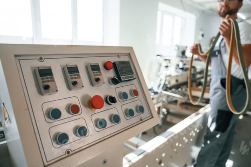 Preview: Standing by the machine. Handsome man is working at the factory of creating eco boxes