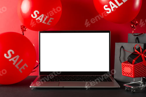 Preview: Get ready for Cyber Monday: side view laptop with an empty screen, a mini cart holding a gift box