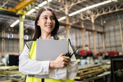 Preview: Asian beautiful woman industrial worker working in manufacturing plant.