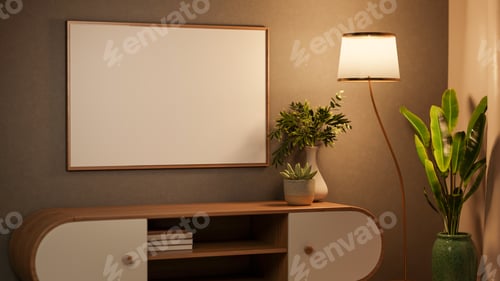 Preview: White blank frame on wall over wooden bookshelf table under lamp light and banana tree in green vase