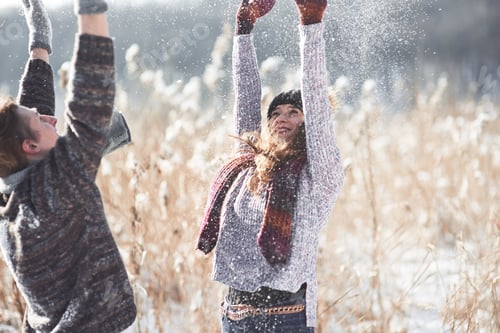 Preview: Couple has fun and laughs. kiss. Young hipster couple hugging each other in winter park. Winter love