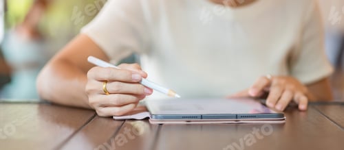 Preview: woman using tablet for sms messages, hand holding pencil typing touchscreen mobile phone in cafe or