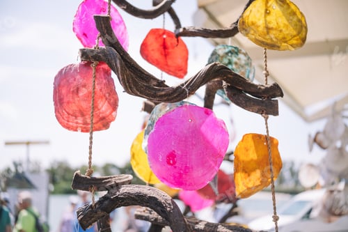 Preview: Wind chimes made with colored shells and pieces of wood.