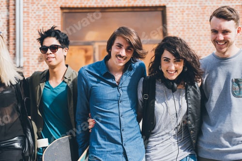 Preview: Group of friends skaters walking outdoors having fun hugging