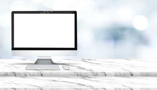 Preview: Blank screen of desktop computer on step white marble table with blur hospital at background