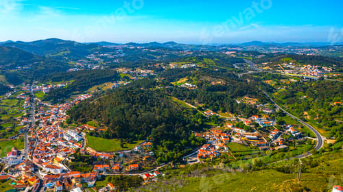 Preview: Drone view of a beautiful small European city with a beautiful hilly landscape on a summer day.