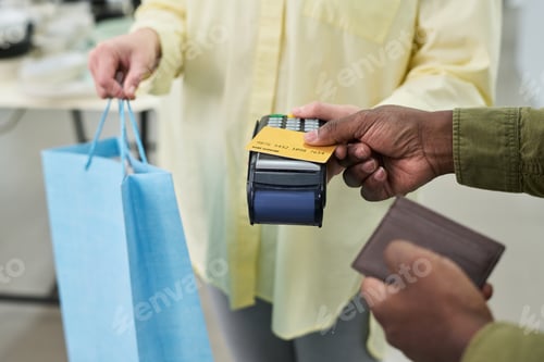 Preview: Caucasian Woman Handing Shopping Bag While Black Man Making Payment