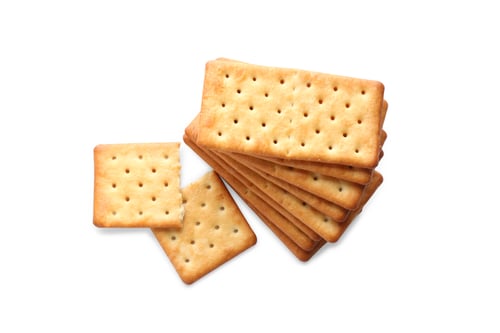 Preview: Stack of delicious crispy crackers isolated on white, top view