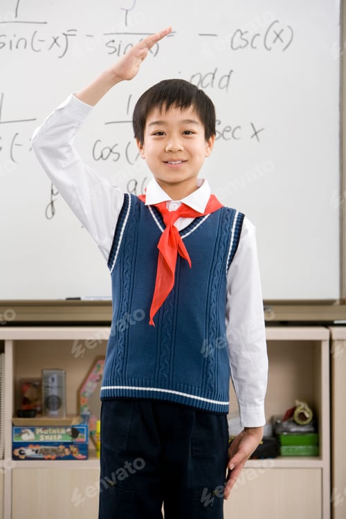 Preview: Young student saluting in front of whiteboard