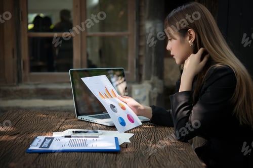 Preview: business woman working with documents graphs ,analyzing investment chart working in office.