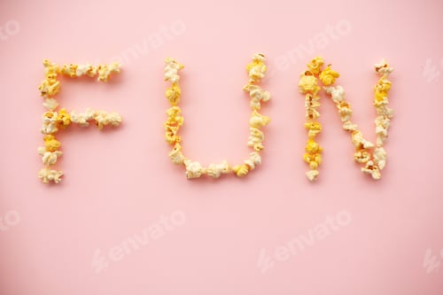 Preview: Food. Word of Fun. Popcorn bucket. Delicious Popcorn on Pink Background. Cinema.