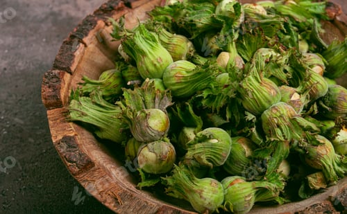 Preview: Fresh, green hazelnuts, close-up, in a wooden bowl, unpeeled, top view, no people,