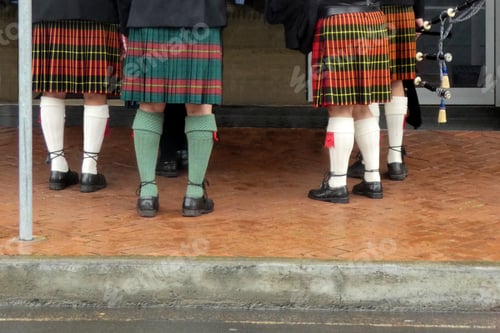 Preview: low section of people wearing kilts