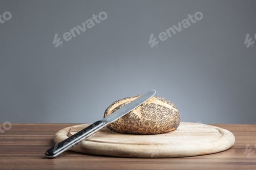 Preview: Poppy seed roll with knife on plate