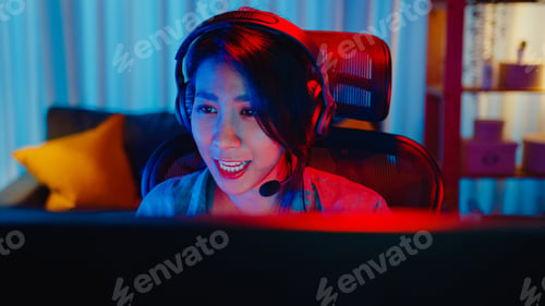 Preview: asia professional girl gamer wear headphone competition play video game neon light.