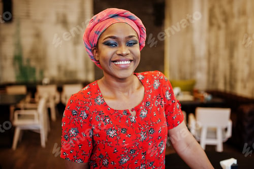 Preview: Stylish african woman in red shirt and hat