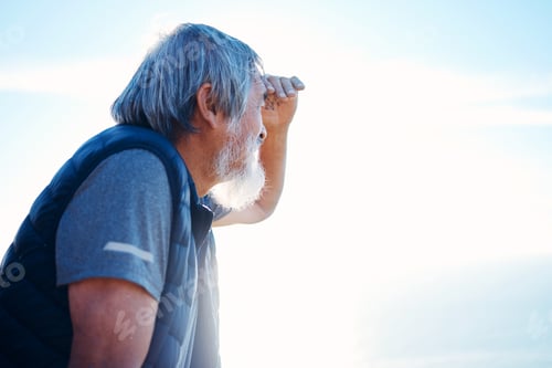 Preview: Search, looking and mature man in nature for hiking, travel and holiday to relax on a blue sky. Env