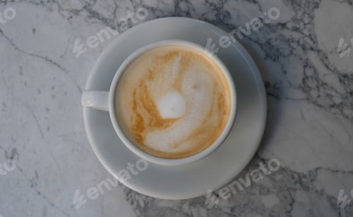Preview: Foamy Cappuccino on a Saucer with Marble Background