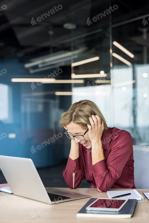 Preview: Businesswoman screaming in frustration feeling overwhelmed by deadline